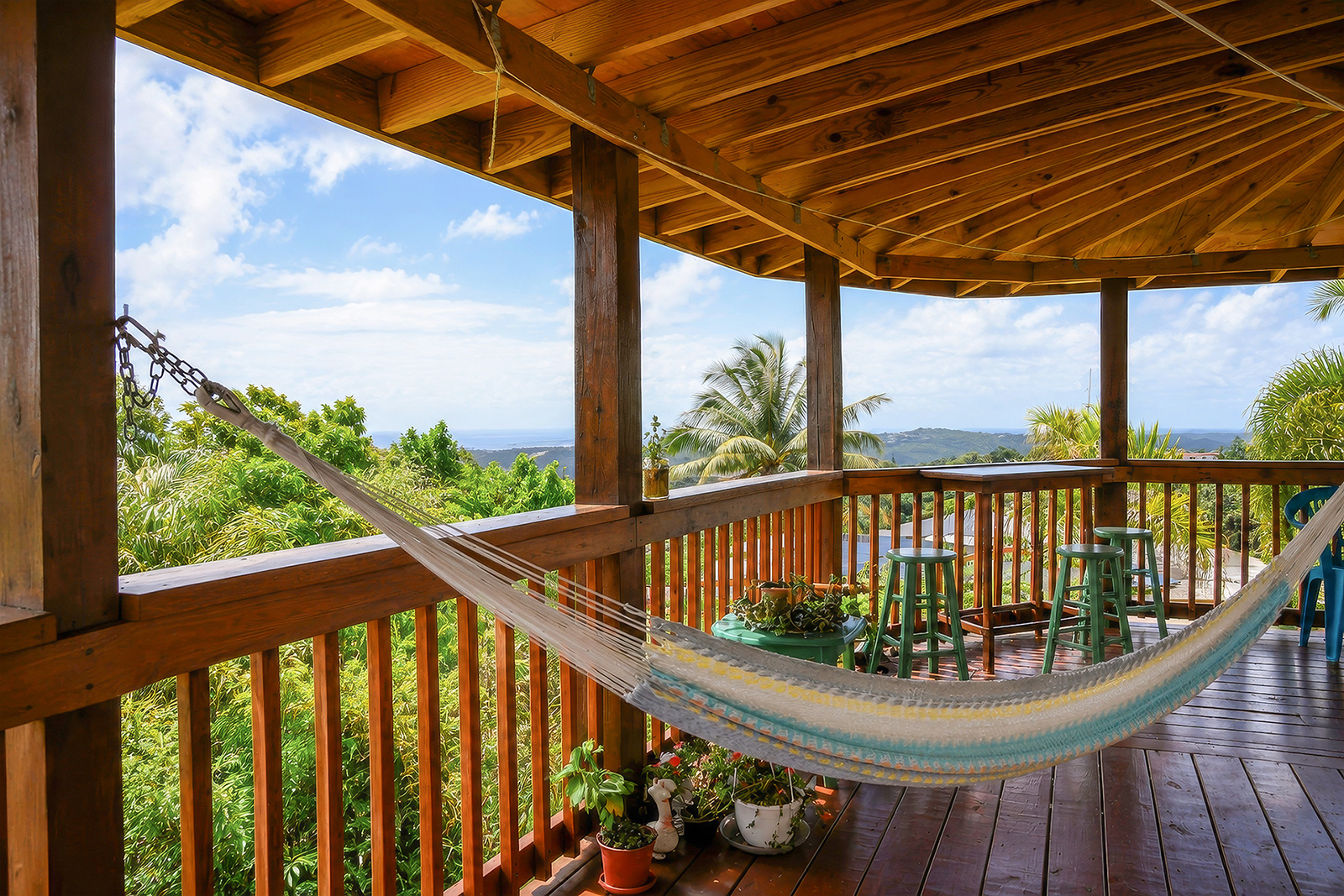 Covered mountain terrace with hammock and panoramic San Juan views at El Chalet Puerto Rico